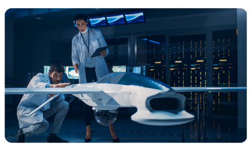 Two engineers testing the aerodynamics of a model aircraft. 